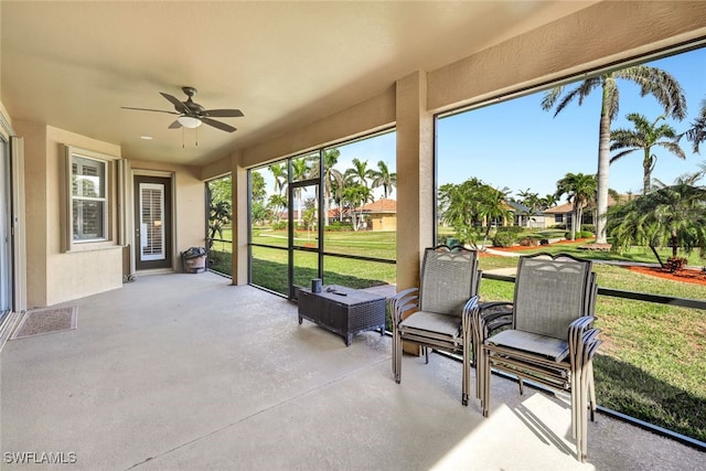 sunroom / solarium featuring ceiling fan