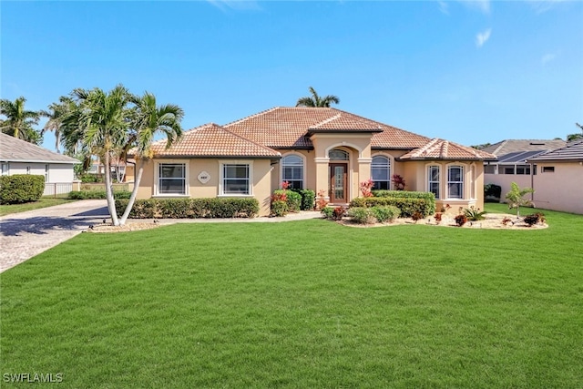 mediterranean / spanish-style home with a front yard