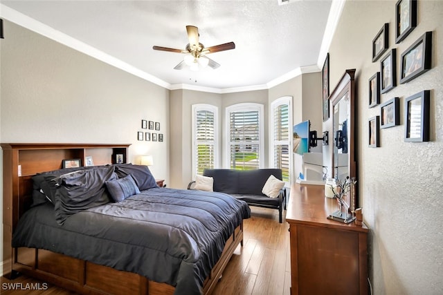 bedroom featuring crown molding, hardwood / wood-style floors, and ceiling fan