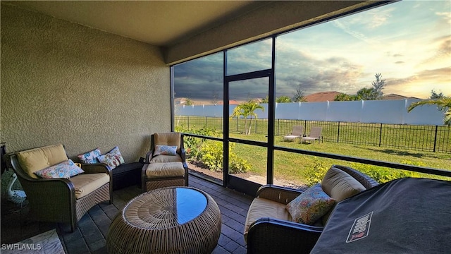 sunroom / solarium featuring a water view