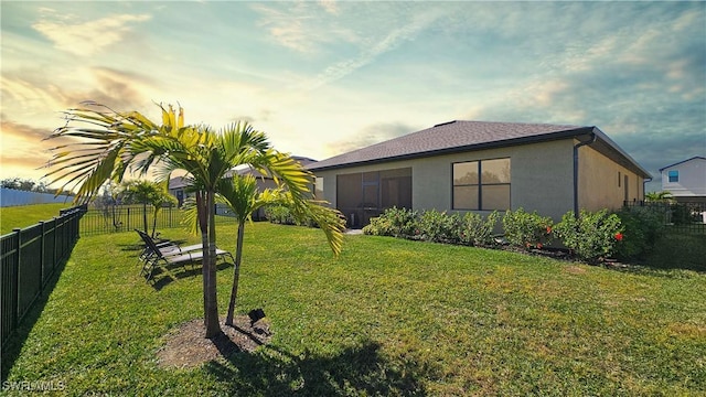 view of yard at dusk