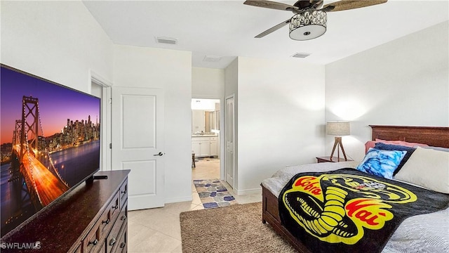 tiled bedroom with connected bathroom and ceiling fan