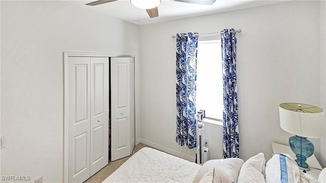 bedroom featuring ceiling fan and a closet