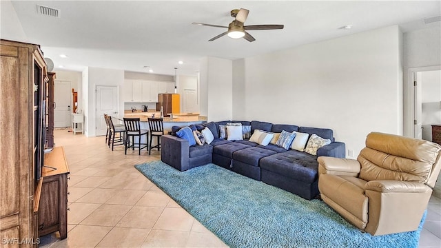 tiled living room featuring ceiling fan