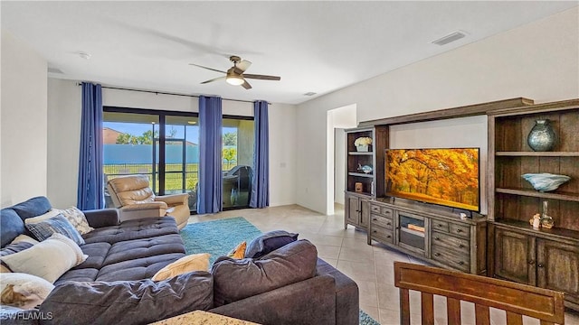 tiled living room featuring ceiling fan