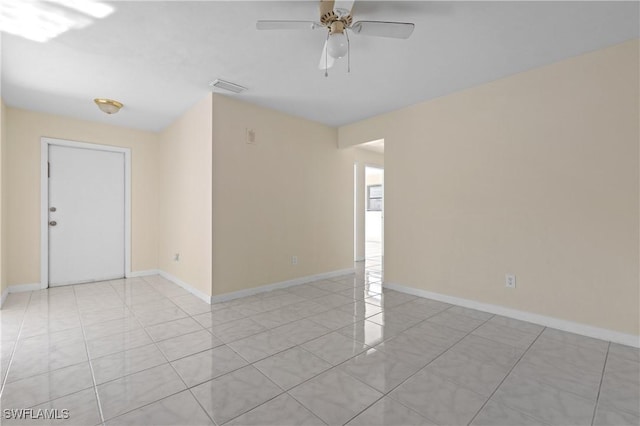 empty room featuring ceiling fan and light tile patterned floors