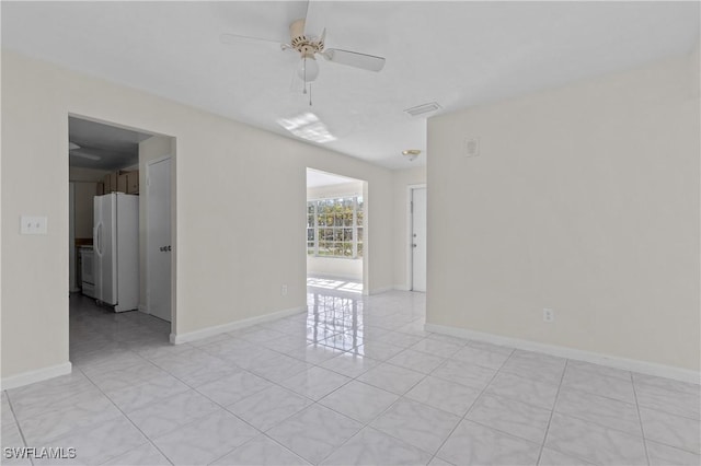 unfurnished room with light tile patterned flooring and ceiling fan