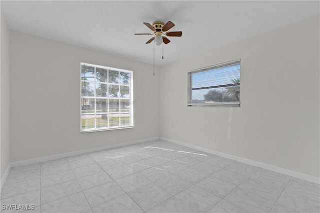 unfurnished room with a wealth of natural light and ceiling fan