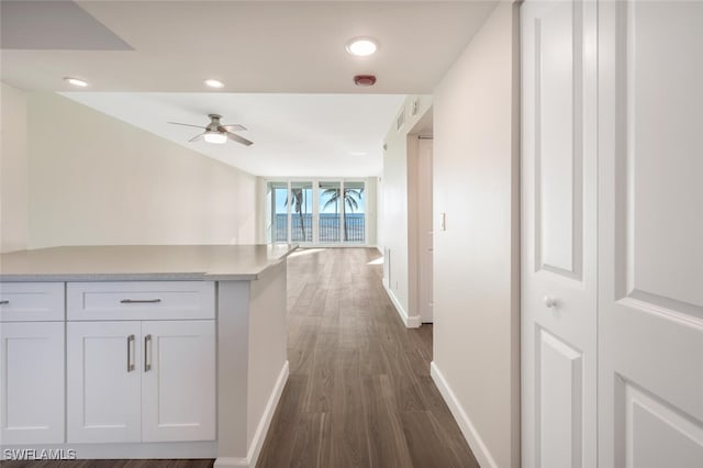 hallway with dark wood-style floors, recessed lighting, and baseboards