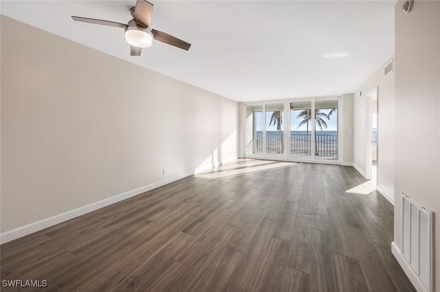 7930 Estero Blvd, Fort Myers Beach, FL 33931 - spare room featuring dark wood-type flooring, ceiling fan, and baseboards