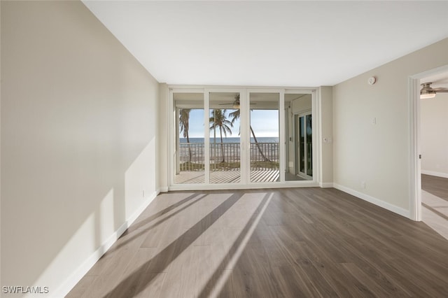 7930 Estero Blvd, Fort Myers Beach, FL 33931 - spare room featuring dark wood finished floors, baseboards, a smoke detector, and floor to ceiling windows