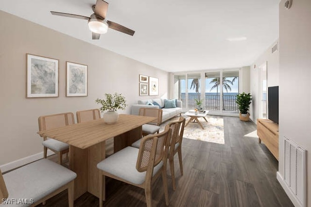 7930 Estero Blvd, Fort Myers Beach, FL 33931 - dining area with dark wood finished floors, a ceiling fan, and baseboards