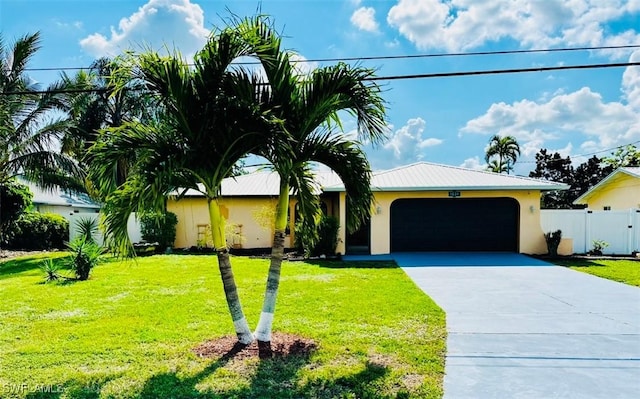 view of front of property featuring a garage and a front lawn