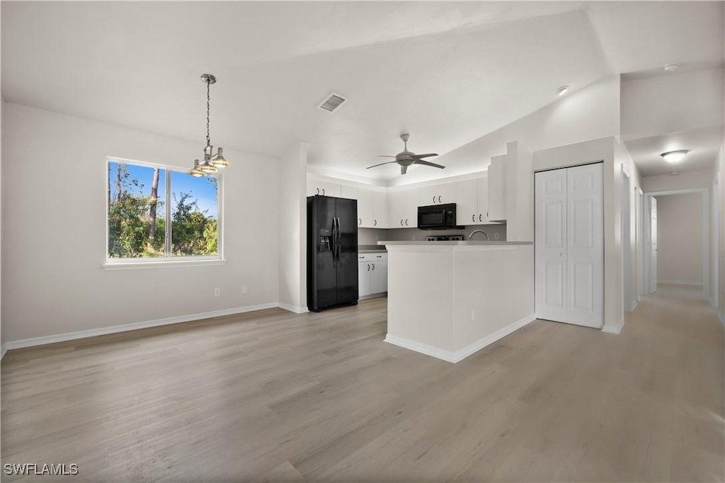 kitchen featuring pendant lighting, light hardwood / wood-style flooring, ceiling fan, black appliances, and white cabinets