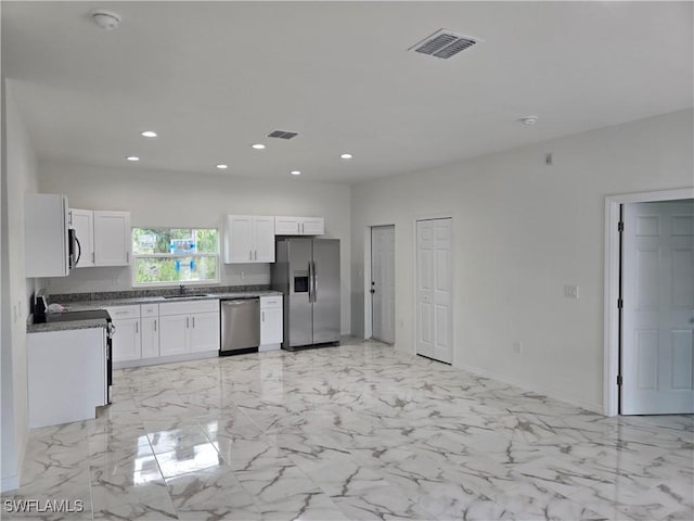 kitchen featuring sink, white cabinets, and appliances with stainless steel finishes