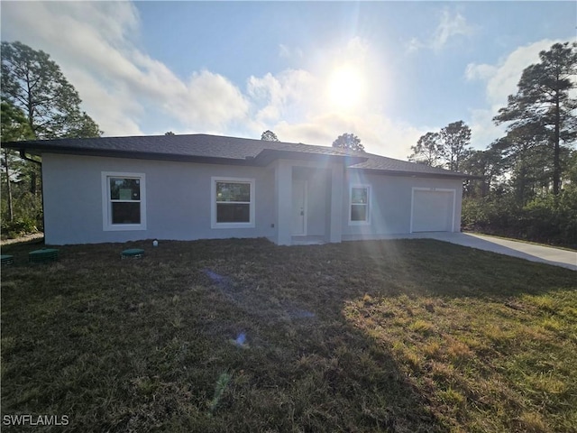 ranch-style house with a garage and a front lawn