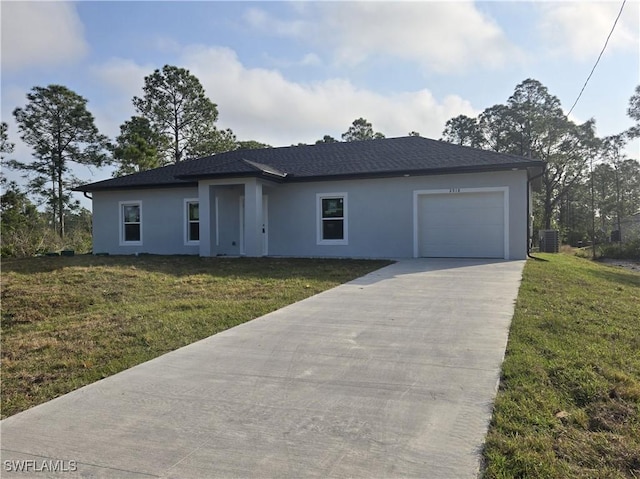 view of front of house with a garage and a front lawn