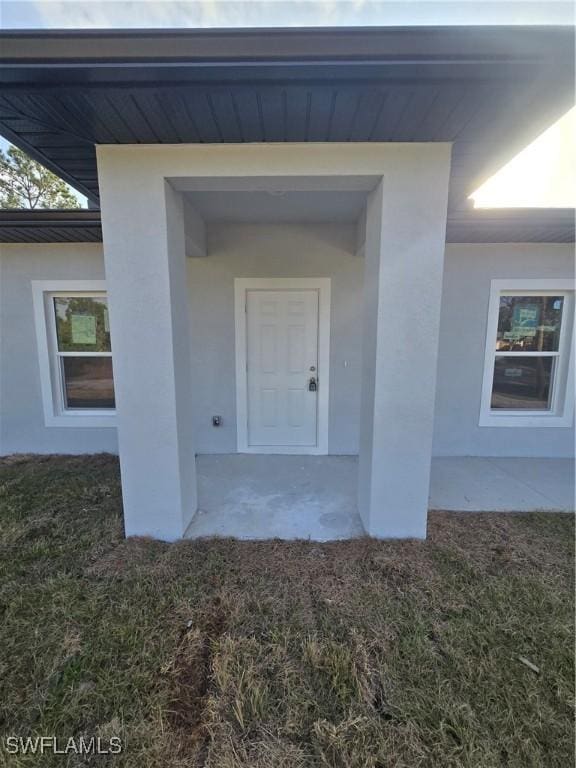 doorway to property featuring a yard