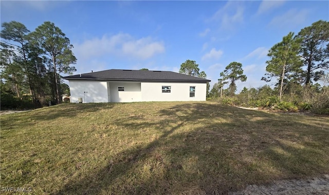 rear view of property with a yard