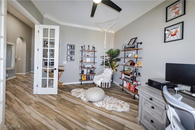 home office featuring crown molding, ceiling fan, and light hardwood / wood-style floors