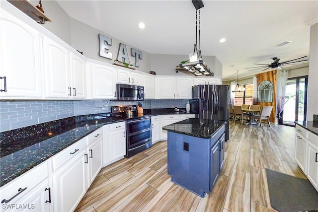 kitchen with appliances with stainless steel finishes, dark stone counters, hanging light fixtures, and white cabinets