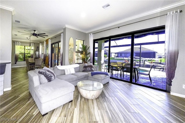 living room featuring ornamental molding, hardwood / wood-style floors, and ceiling fan