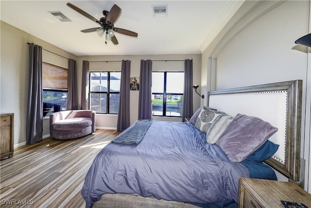 bedroom with light hardwood / wood-style flooring and ceiling fan