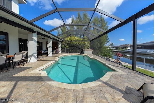 view of swimming pool with a water view, ceiling fan, a lanai, and a patio