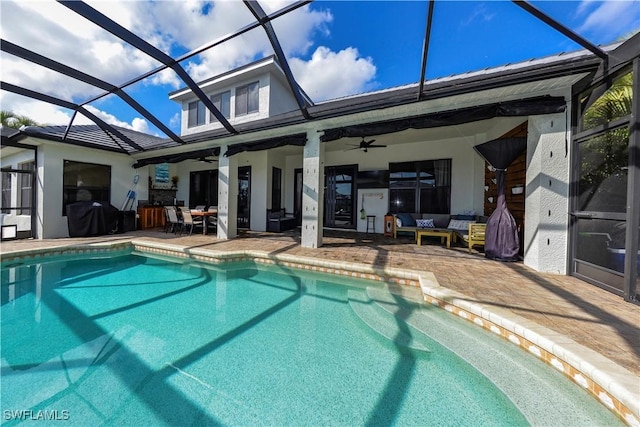 view of swimming pool with an outdoor hangout area, a patio, ceiling fan, and glass enclosure