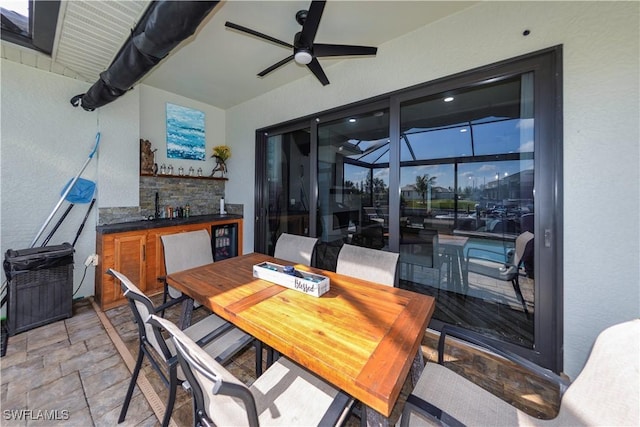 view of patio featuring ceiling fan and a lanai