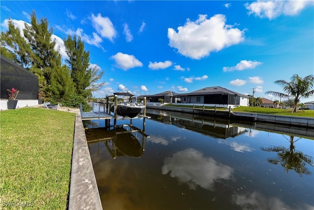 dock area with a water view, a yard, and a lanai