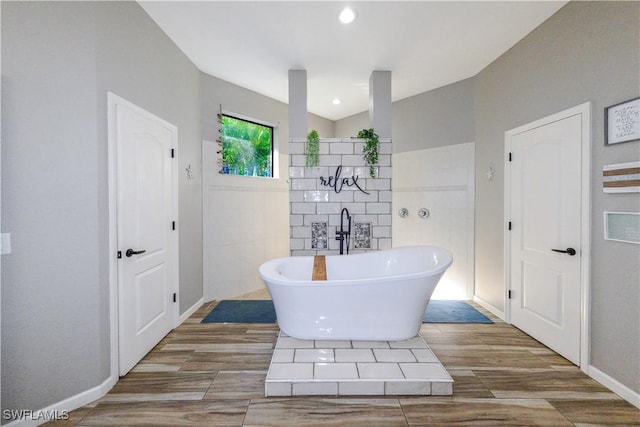 bathroom with tile walls and a bathtub