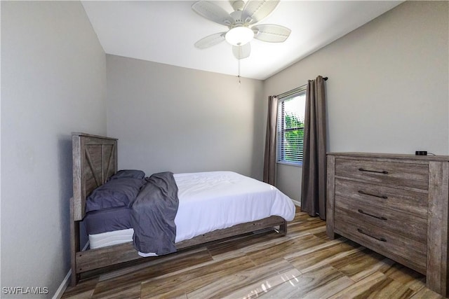 bedroom with ceiling fan and wood-type flooring