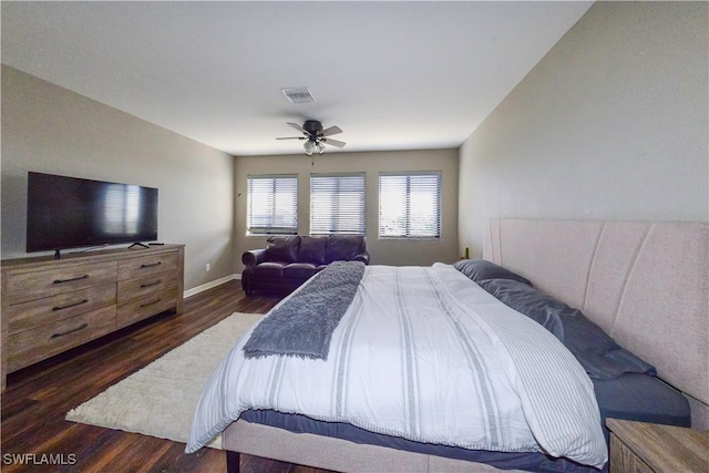 bedroom with dark hardwood / wood-style flooring and ceiling fan