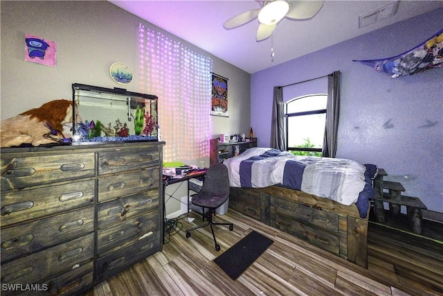 bedroom with ceiling fan and hardwood / wood-style floors