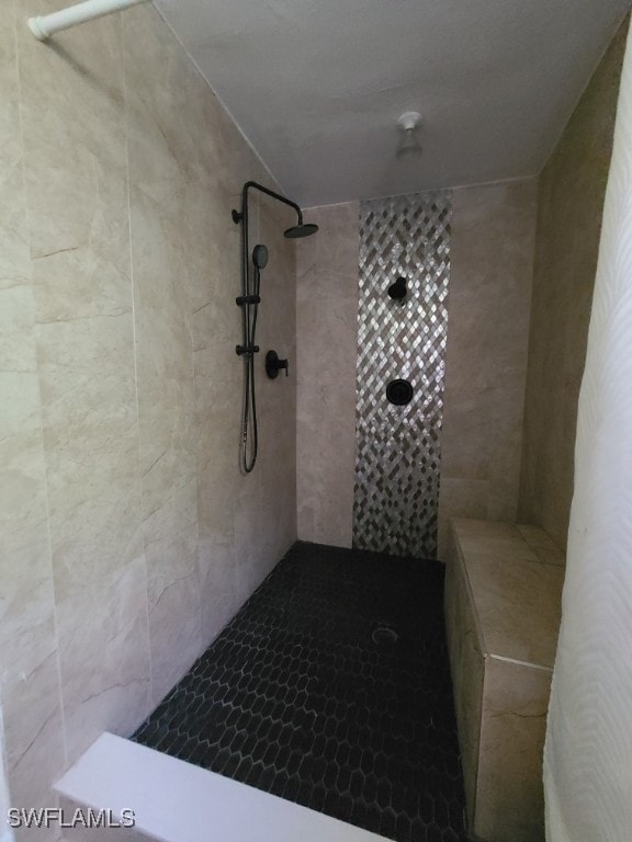 bathroom with tiled shower