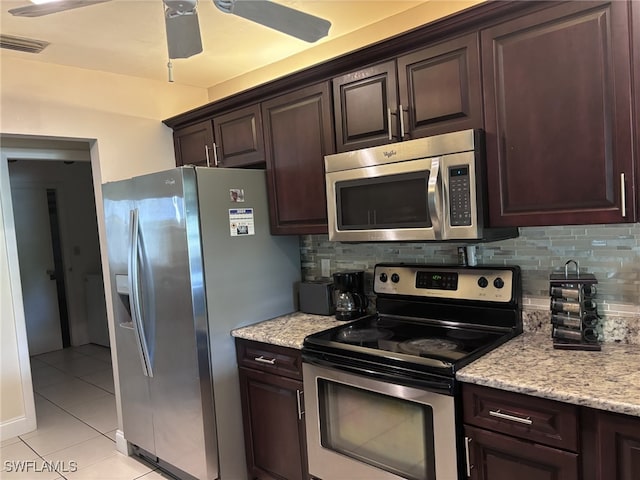 kitchen with appliances with stainless steel finishes, visible vents, decorative backsplash, and light tile patterned flooring