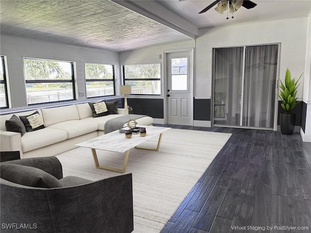 living area featuring ceiling fan, dark wood-style flooring, and baseboards