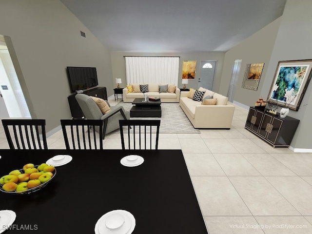 living area with vaulted ceiling, light tile patterned flooring, and baseboards