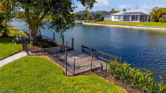 dock area with a water view and a yard