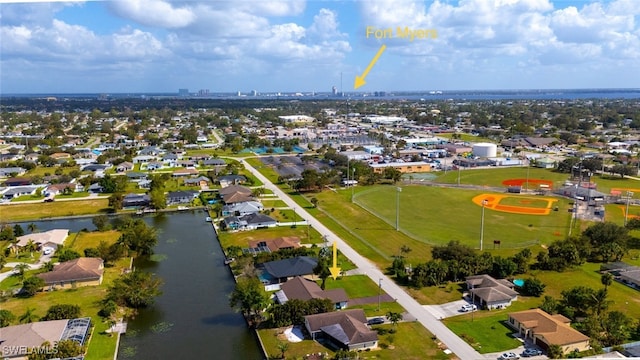 birds eye view of property with a water view and a residential view