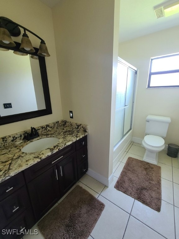 bathroom with tile patterned flooring, toilet, vanity, and baseboards