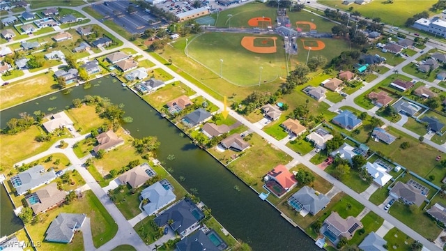 drone / aerial view featuring a residential view and a water view