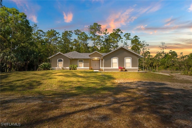 ranch-style house featuring a yard