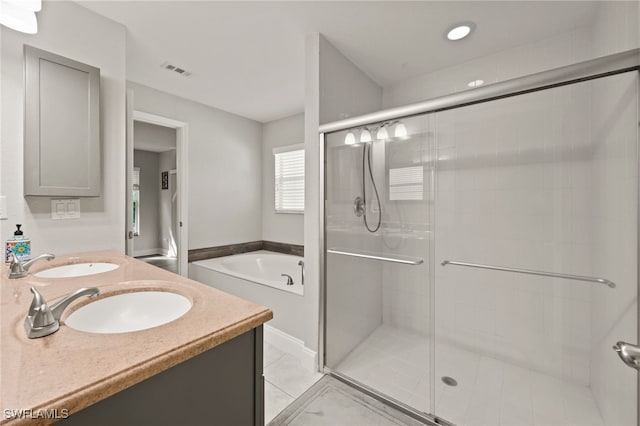 bathroom featuring vanity, tile patterned flooring, and plus walk in shower