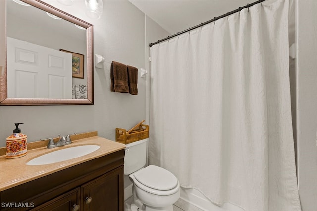 bathroom featuring vanity, toilet, and walk in shower