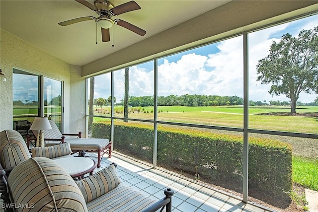 sunroom featuring ceiling fan