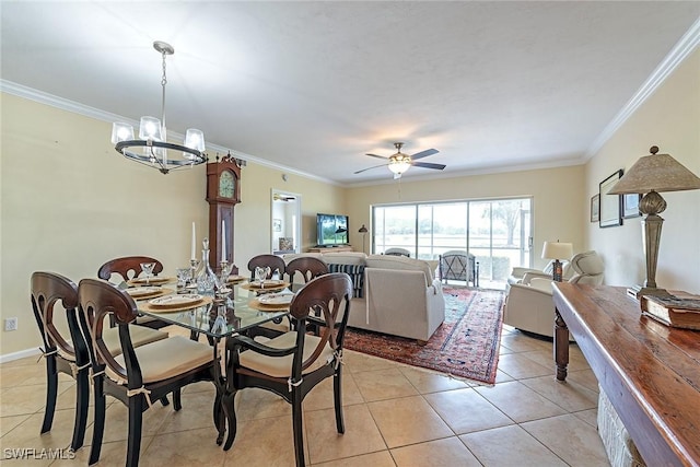 tiled dining room featuring ornamental molding and ceiling fan with notable chandelier