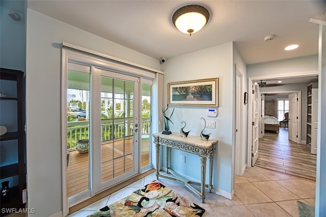 doorway to outside featuring light tile patterned flooring