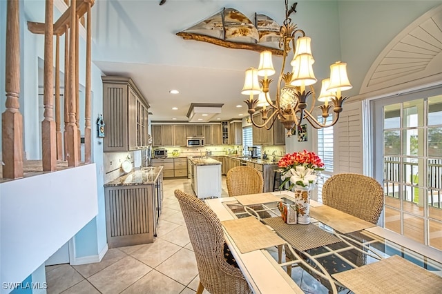 dining space featuring an inviting chandelier and light tile patterned floors